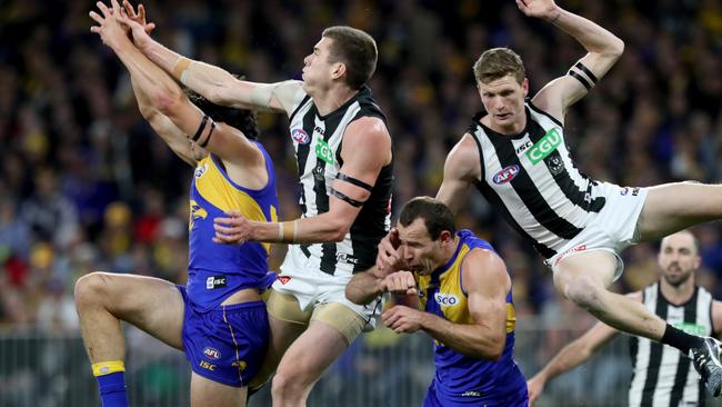 Mason Cox (second left) and Will Hoskin-Elliott fly in a marking contest against Tom Barrass and Shannon Hurn. Picture: AAP Image/Richard Wainwright.