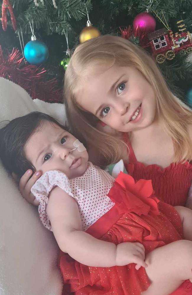 Mackay three-year-old Seraphina with her baby sister Ariella who has had a rocky start to life with a hole in her heart developing into two holes. Picture: Contributed