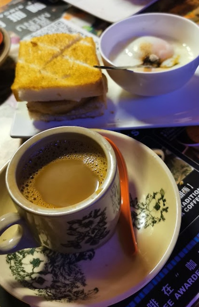 Traditional breakfast – toasted bread with kaya and thin slices of butter, kopi, and soft-boiled eggs seasoned with pepper and dark soy sauce. Coffee is made from beans sauteed in margarine and sugar.