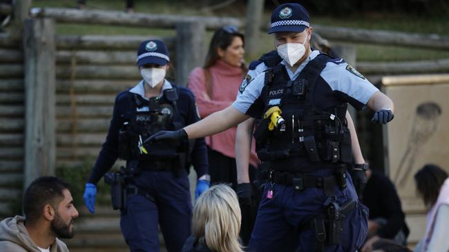 Police move on part of a large crowd who had gathered near the grassy knoll at North Bondi, apparently breaking social distancing rules. Picture: Damian Shaw