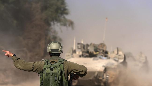 Israeli troops near the border fence between Israel and the Gaza Strip ahead of an operation in the north of the Palestinian enclave. Picture: DaphnÃ© LEMELIN / AFP