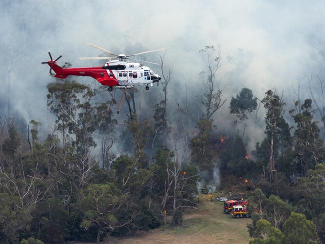 Firefighters tackle the blaze in difficult conditions. Picture: Jason Edwards