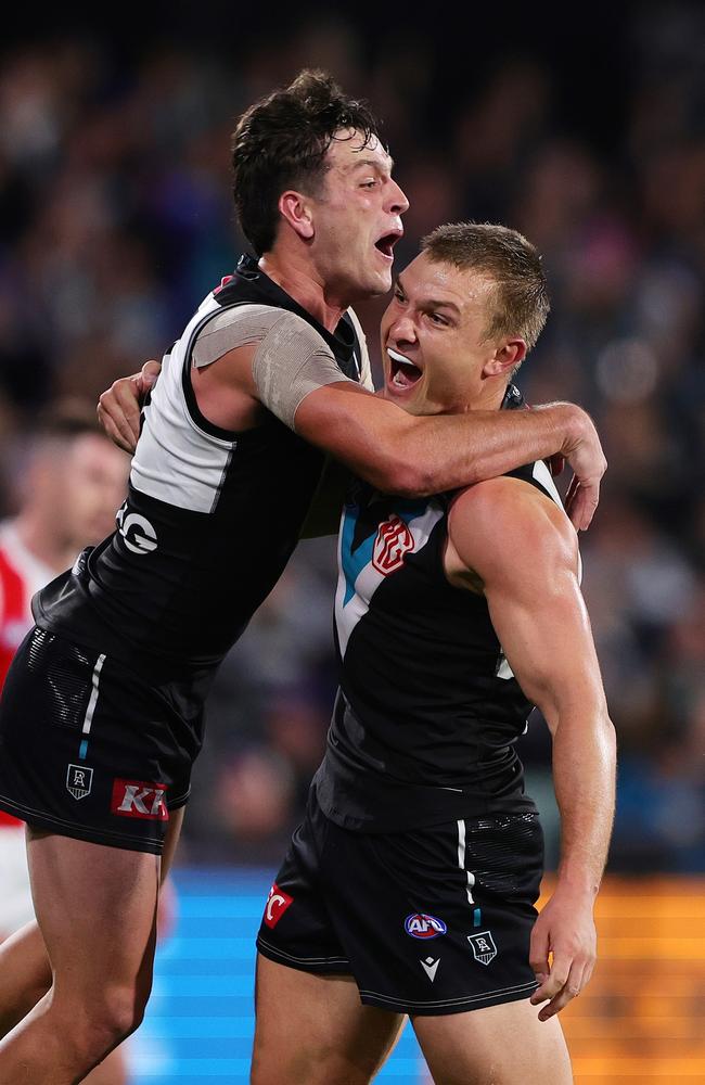 Ollie Wines celebrates a goal with Zak Butters during his side’s win over Geelong. Picture: Sarah Reed/AFL Photos via Getty Images.