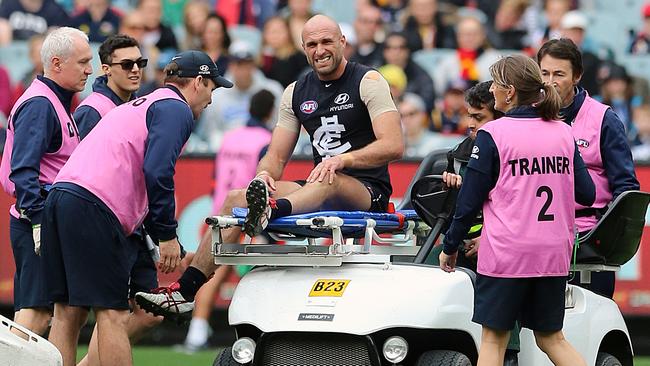 Chris Judd is stretchered off with a knee injury. Picture: Alex Coppel