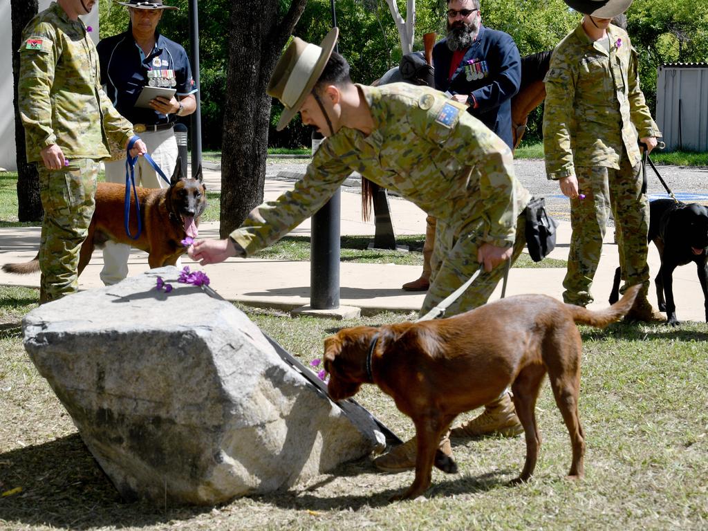 Sapper Minh Le with EDD Kiz from 3CER lays a poppy. Picture: Evan Morgan