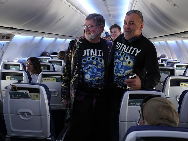 Passengers don eclipse-themed shirts on Southwest flight 1252 from Dallas to Pittsburgh, eagerly anticipating the total solar eclipse path mid-air. Picture: Justin Sullivan/Getty Images