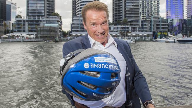 Terminator Arnold Schwarzenegger carries a Melbourne Bike Share helmet in Docklands. Picture: Jason Edwards