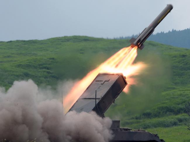 (FILES) This file photo taken on August 20, 2013 shows a Japanese Ground Self-Defense Force type-92 anti-mine rocket launcher firing a missile during an annual live fire exercise at the Higashi-Fuji firing range in Gotemba, at the foot of Mt. Fuji in Shizuoka prefecture. - Japan announced on December 16, 2022 its biggest defence overhaul in decades, hiking spending, reshaping its military command and acquiring new missiles to tackle the threat from China. (Photo by Toshifumi KITAMURA / AFP)