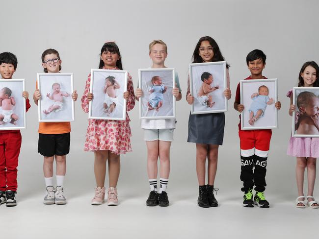 100 Babies 10 years on. 10 year olds - Andy Zhu, Koby Robertson, Emaira Tomar, Ben Steinhauser, Saira Bakshi, Ruansh Chowdhury, Bianca Sommers hold photos of them as babies. Picture: David Caird                           Picture: David Caird