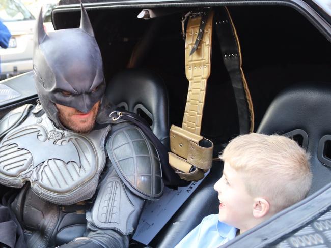 Finn O'Donovan buckles up for his ride with his hero in the Batmobile.