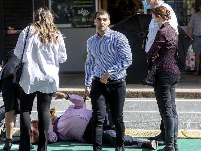 Ali Ebrahimi checks on his barrister Peter Nolan after he fell outside of the Brisbane Supreme Court. Picture: NCA NewsWire / Sarah Marshall