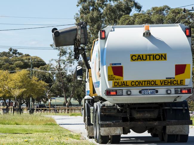 A rubbish truck empties wheelie bins in Langford. The City of Gosnells plans to implement wheelie bin 'police', fining people for leaving wings out for too long or for putting the incorrect items in the recycling bin.