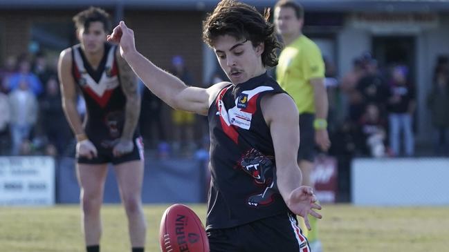 Alex Canal takes a kick for Devon Meadows. Picture: Valeriu Campan