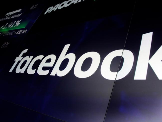 FILE - In this March 29, 2018, file photo, the logo for Facebook appears on screens at the Nasdaq MarketSite, in New York's Times Square. Aleksandr Kogan, the data scientist at the center of Facebookâ€™s Cambridge Analytica privacy scandal, said he is dropping a defamation lawsuit against the social network rather than engage in an expensive, drawn-out legal battle. (AP Photo/Richard Drew, File)