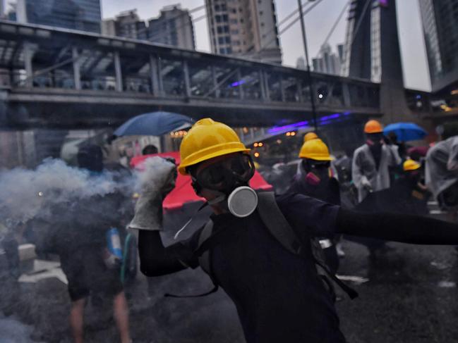 Protesters return tear gas in Tseun Wan in Hong Kong on August 25, 2019. Picture: AFP