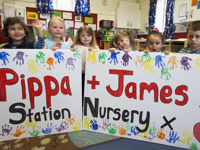 Children at the Old Fire Station nursery in Englefield, Berkshire, with their wedding poster. Picture: Stephen Lock/i-Images.