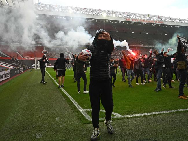 Supporters protest against Manchester United's owners, inside English Premier League club Manchester United's Old Trafford stadium in Manchester, north west England on May 2, 2021, ahead of their English Premier League fixture against Liverpool. - Manchester United were one of six Premier League teams to sign up to the breakaway European Super League tournament. But just 48 hours later the Super League collapsed as United and the rest of the English clubs pulled out. (Photo by Oli SCARFF / AFP)