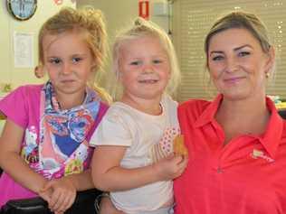 PUTTING IN PINK: Summer and Mac Jolly and Kylie Schweikert holding the fort at Gayndah Golf Club's event to raise money for breast cancer and prostate cancer charities. Picture: Felicity Ripper