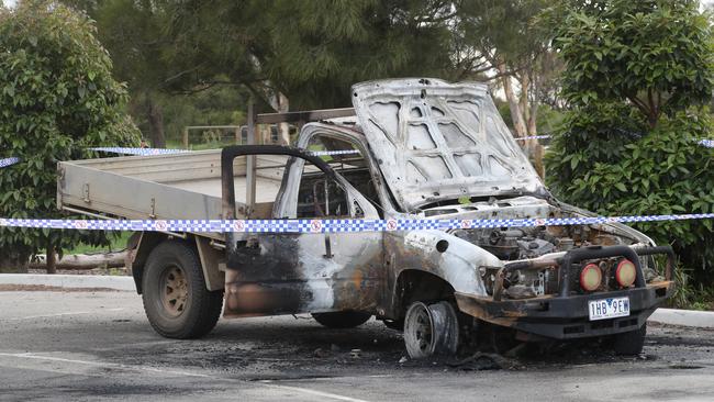 A burnt-out car in Altona under police guard at PA burns Reserve. Picture: David Crosling