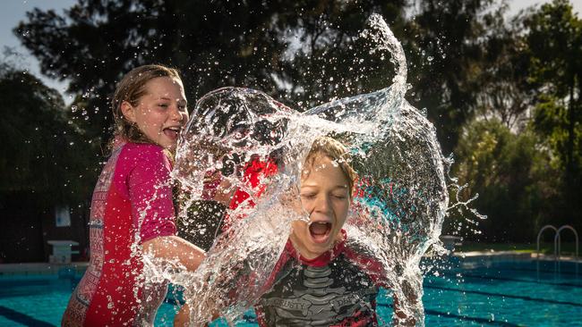 Zara, 11, and Dash, 10, cool down at the Leigh Creek pool. Picture: Brad Fleet