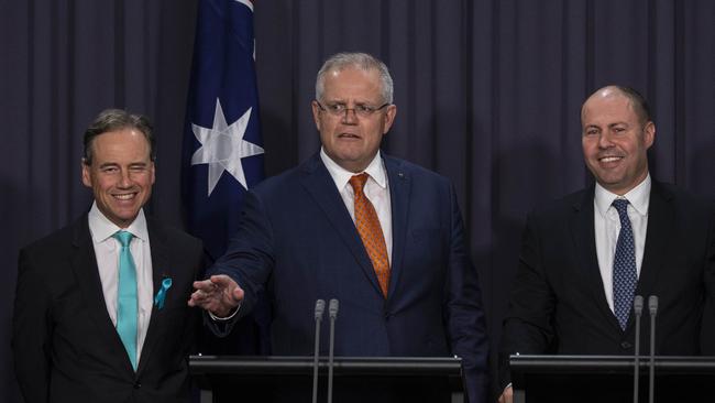 Prime Minister Scott Morrison flanked by Health Minister Greg Hunt and Tresurer Josh Frydenberg. Picture: Gary Ramage