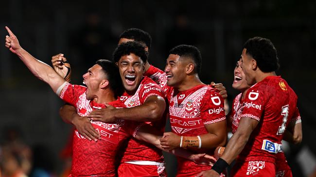 Tonga celebrates during its stunning upset over New Zealand in Auckland. (Photo by Hannah Peters/Getty Images)