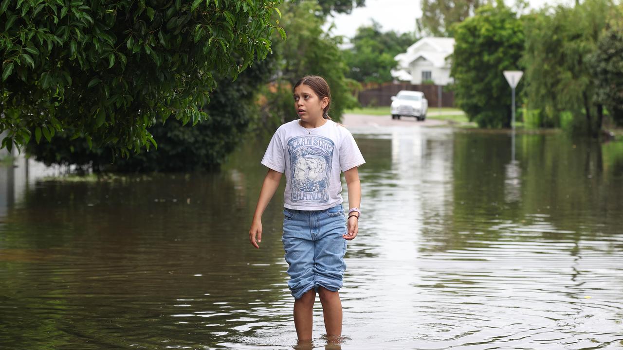 Annabella Giorgas 11 walks along her street in Hermit Park as Townsville residents endure another day of heavy rain and threats of catastrophic flooding. Pics Adam Head