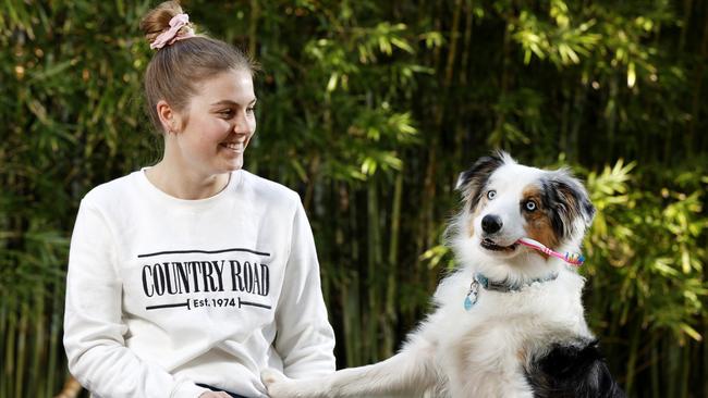 Dog owners are urged to brush their dogs teeth more regularly to fight dental disease. Alex Coleman, 22, with her border collie Gypsy at home in Cronulla. Picture: Jonathan Ng