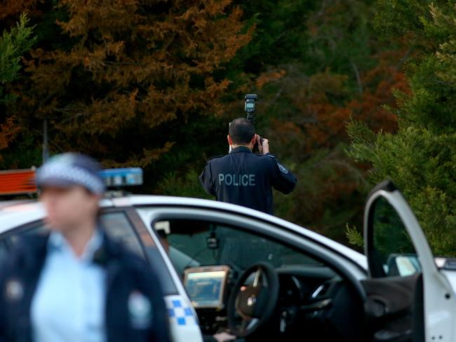 A police photographer at the scene where two skydivers died. Picture: Damian Shaw