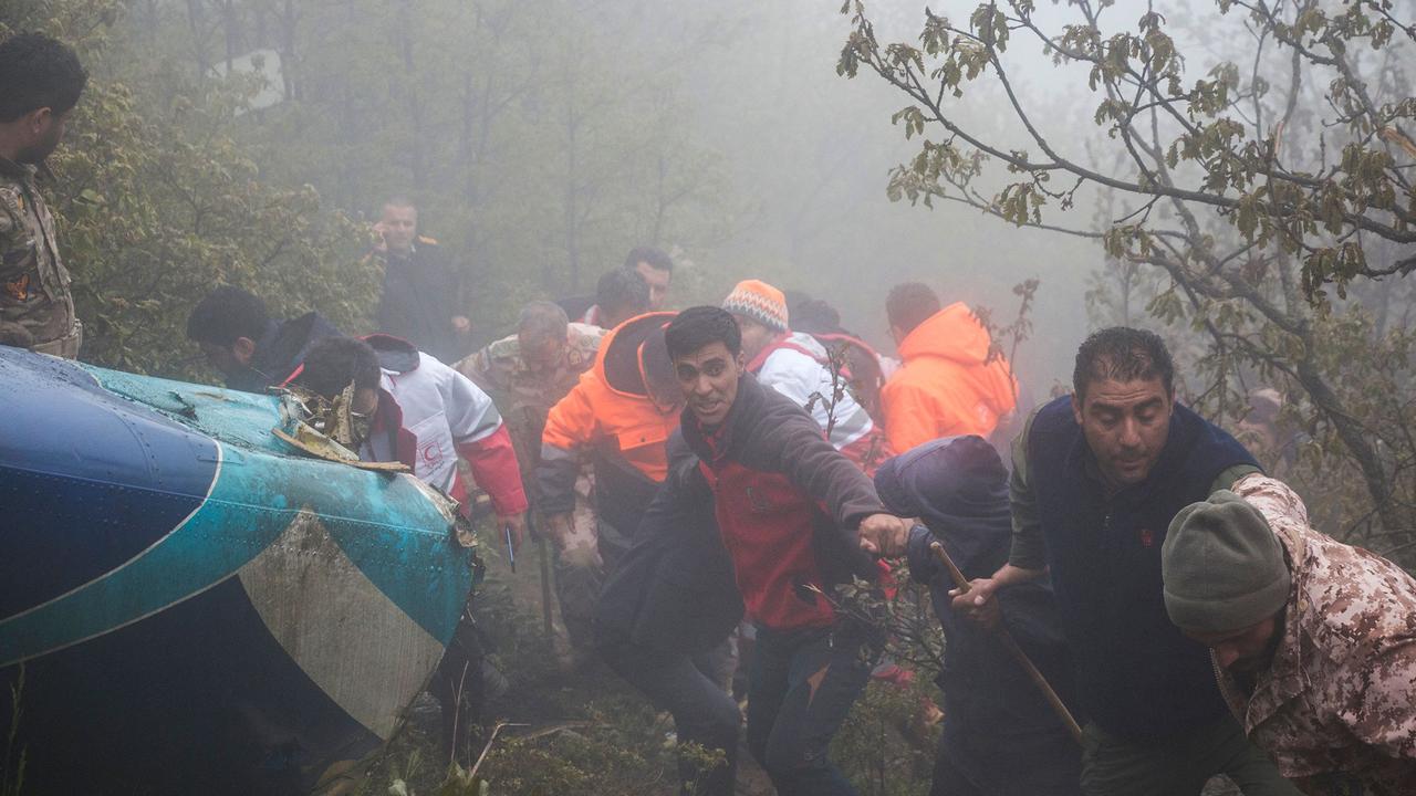 Rescuers work at the crash site. Picture: Azin Haghighi/MOJ News Agency/AFP