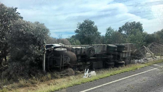 The truck overturned just off of the Warrego Hwy.