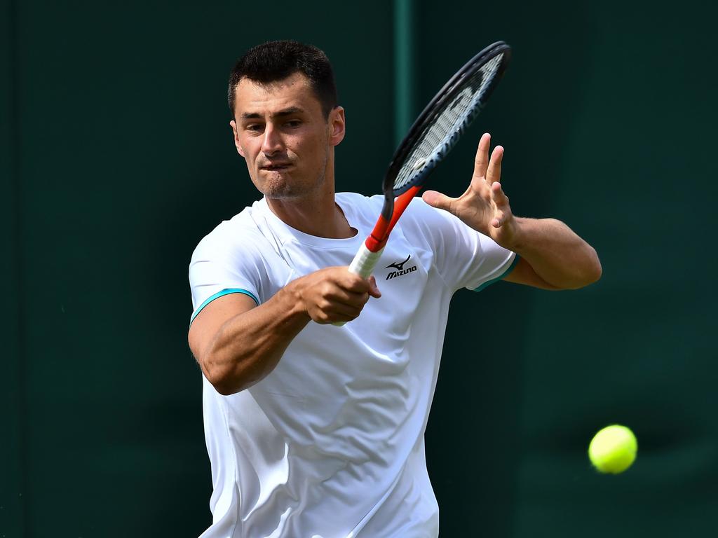 Australia's Bernard Tomic returns against France's Jo-Wilfried Tsonga. (Photo by Ben STANSALL / AFP)