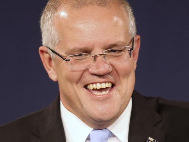 FILE - In this  May 19, 2019, file photo, Australian Prime Minister Scott Morrison, second right, speaks to party supporters flanked by his wife, Jenny, second left, and daughters Lily, right, and Abbey, after his opponent concedes in the federal election in Sydney, Australia. Australiaâ€™s newly reelected administration says its promise to slash income taxes might be delivered late but wonâ€™t be broken as the government hopes to stimulate consumer spending and revive a flagging economy. (AP Photo/Rick Rycroft, File)