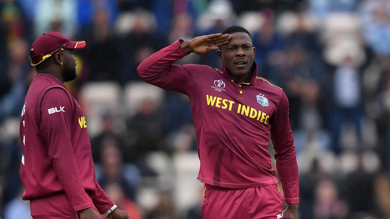 Sheldon Cottrell celebrates with his trademark salute when he takes a wicket. Photo: by Alex Davidson/Getty Images.