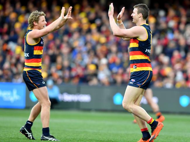 Rory Sloane and Josh Jenkins celebrate a goal during the win against North Melbourne.