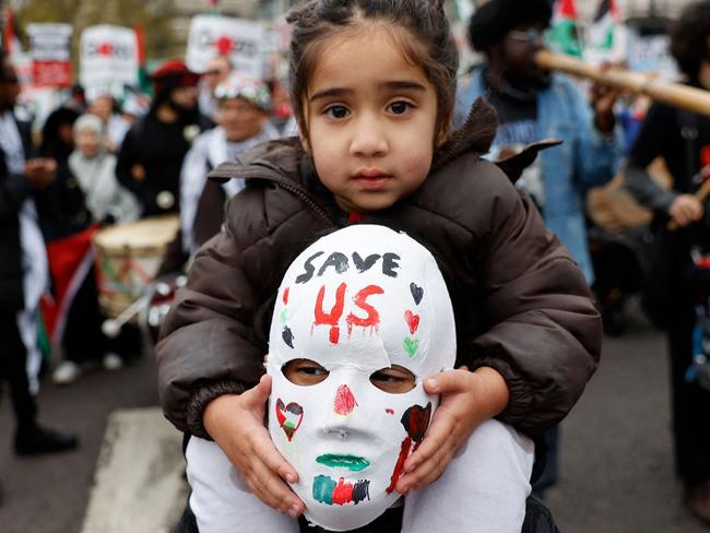 A child is given a ride by a protester during a national demonstration for Palestine and Lebanon, in central London, on November 30, 2024. Israeli Prime Minister Benjamin Netanyahu threatened Hezbollah on November 28, 2024 with an "intensive war" if it breaches a fragile Lebanon ceasefire, which on its second day is straining under pressure from both sides. Lebanon says at least 3,961 people have been killed in the country since October 2023, most of them in recent weeks. Since Hamas's October 7 attack last year that triggered the war, Israel's campaign in Gaza has killed at least 44,382 people, most of them civilians, according to data from the Hamas-run territory's health ministry, which the United Nations considers reliable. (Photo by CARLOS JASSO / AFP)