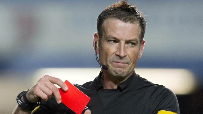 (FILES) A file picture taken on October 28, 2012, shows referee Mark Clattenburg putting away his red card during a match between Manchester United and Chelsea in London. British police said Tuesday November 13, 2012, they had no plans to continue enquiries into a complaint regarding alleged racist comments by referee Mark Clattenburg towards a Chelsea player because no victim had come forward. The Society of Black Lawyers reported Clattenburg to London's Metropolitan Police after Chelsea complained to the Football Association the referee used a term understood to have been interpreted as racist towards John Obi Mikel during the 3-2 Premier League defeat by Manchester United on October 28. AFP PHOTO / ADRIAN DENNIS/FILES RESTRICTED TO EDITORIAL USE. NO USE WITH UNAUTHORIZED AUDIO, VIDEO, DATA, FIXTURE LISTS, CLUB/LEAGUE LOGOS OR 'LIVE' SERVICES. ONLINE IN-MATCH USE LIMITED TO 45 IMAGES, NO VIDEO EMULATION. NO USE IN BETTING, GAMES OR SINGLE CLUB/LEAGUE/PLAYER PUBLICATIONS.