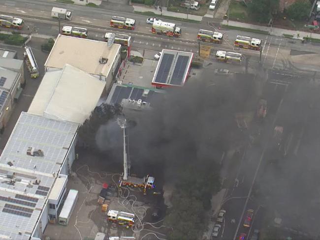 A hundred firefighters are on the scene of an industrial fire in western Sydney which has forced police to set up an exclusion zone. The fire is at an automotive business on Stubbs Street in the suburb of Auburn. At least 20 fire fighting trucks carrying 100 crew have stopped the fire spreading to nearby buildings. Picture: Nine News