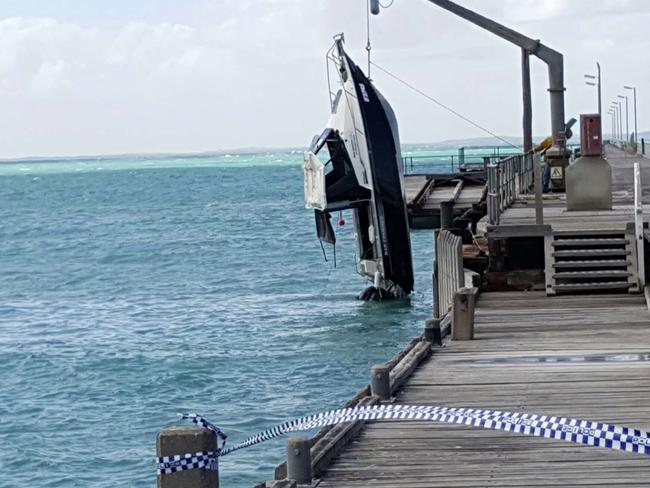 The boat is lifted by a crane ob the Beachport Jetty. Picture: Luke Slater