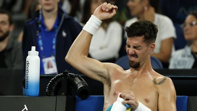 Thanasi Kokkinakis stretches his shoulder during a medical time-out against Jack Draper. Picture: Daniel Pockett/Getty Images