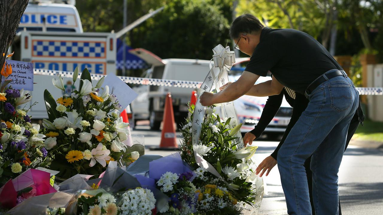 Members of local community leave flowers at the flower shrine for popular doctor Luping Zeng. AAP Image/Richard Waugh