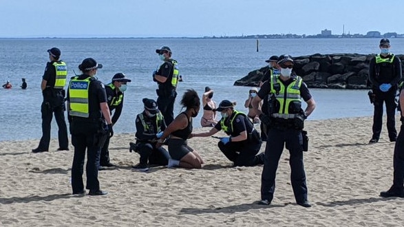 A protester being arrested on Elwood Beach. Picture: Rachel Clayton