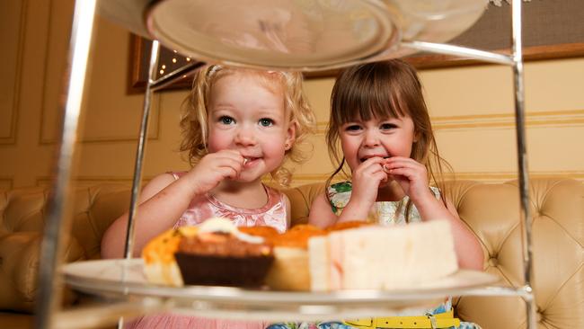 Isabella, 3, and Alyssa, 2, tuck into sweet treats at the Hotel Windsor ahead of school holidays. Picture: Tim Carrafa