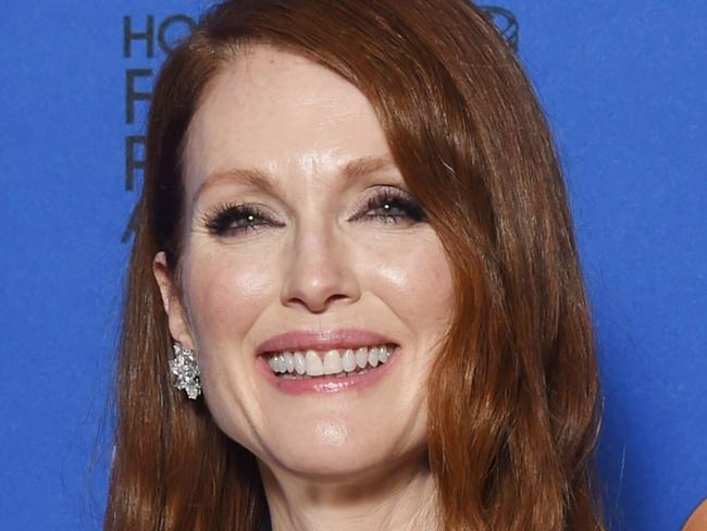 (FILES) This january 11, 2015 file photo shows actress Julianne Moore as she poses with the award for Best Actress - Motion Picture, Drama for her role in "Still Alice," in the press room at the 72nd annual Golden Globe Awards, at the Beverly Hilton Hotel in Beverly Hills, California. In "Still Alice", Julianne Moore plays a woman who has everything, love, children and career, and gradually loses it because of Alzheimer's disease. It is a performance that earned her a Golden Globe and makes her a favorite in the race for Oscars . AFP PHOTO / FREDERIC J BROWN