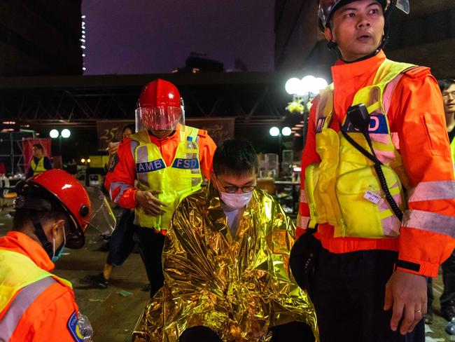 An injured protester is wrapped in an emergency thermal blanket after fleeing from the Hong Kong Polytechnic University campus. Picture: Getty Images