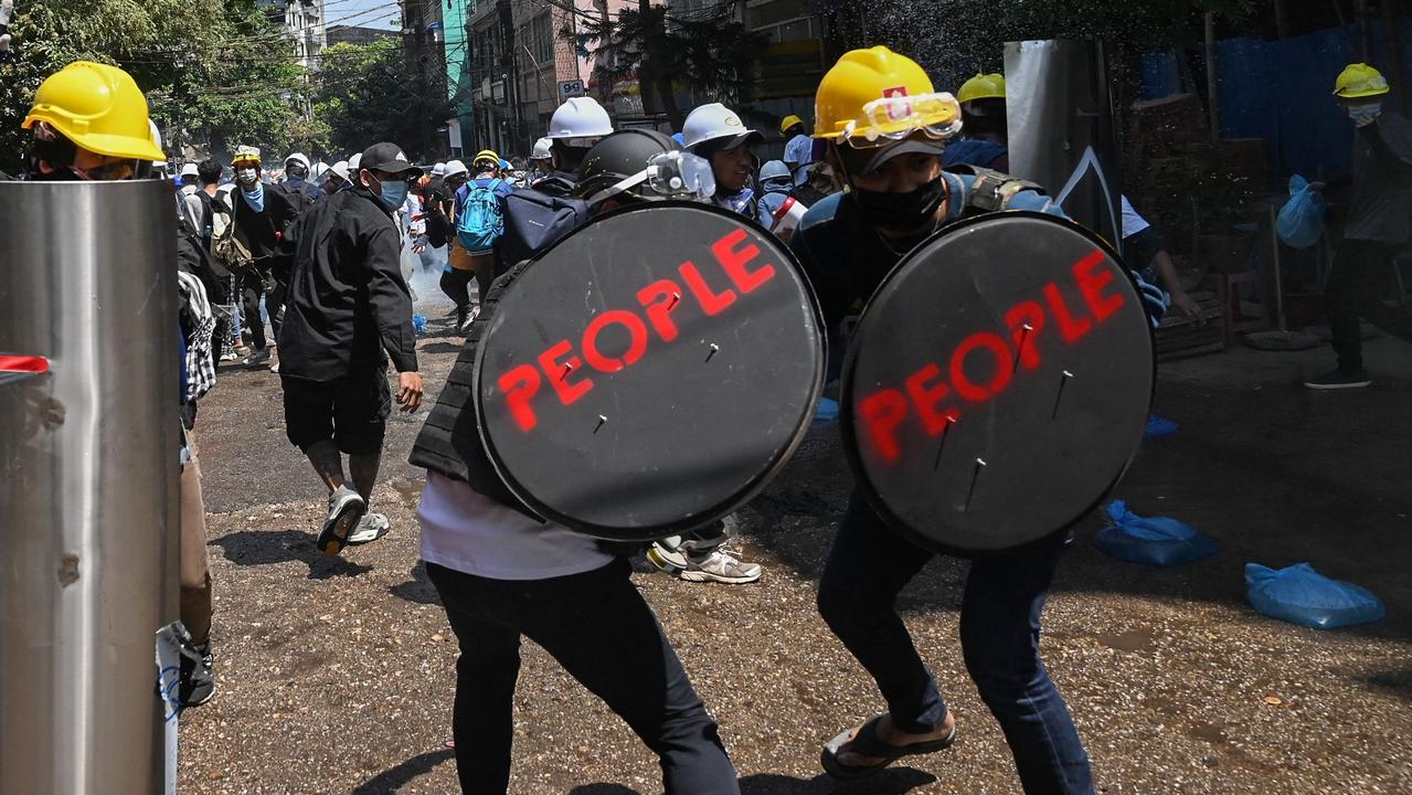 Protesters hold shields with the word ‘PEOPLE’ on them. Picture: STR/AFP