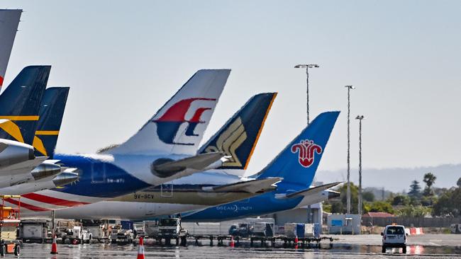 Planes parked up at Adelaide Airport, including a Sinapore Airlines flight. Picture: Brenton Edwards