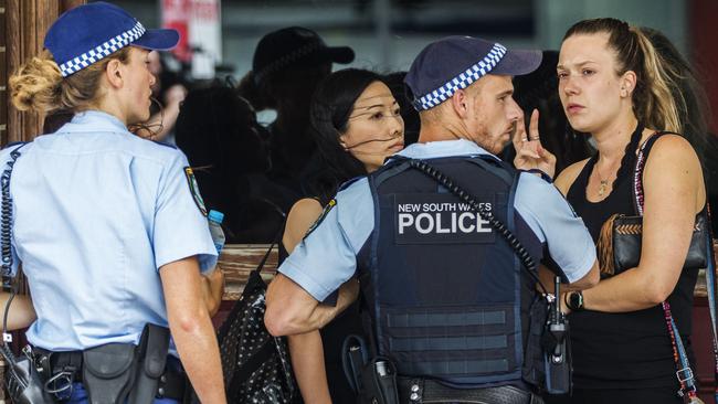 Police talk to witnesses at the front of the hotel. Picture: Jenny Evans.