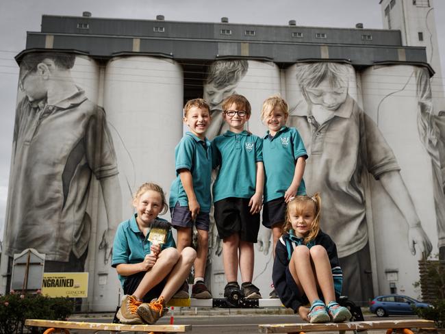 Ciara Johnson, Reef Gregor, Blake Thompson, Kiarah Leske and Macey Jacobs in front of their paintings on the 30-metre high Coonalpyn silo mural by artist Guido van Helten. Picture: Matt Turner