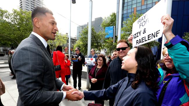 Israel Folau, pictured here greeted by supporters at the Federal Court in 2019.